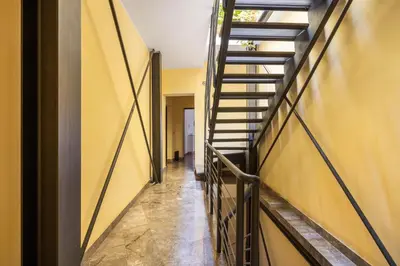 a bedroom with a bed and a yellow sign on the wall at Sedie Volanti Apartment with Jacuzzi in Palermo