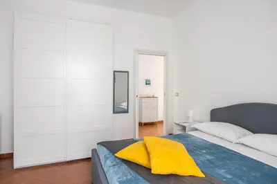 a blue and white bathroom with a tub and a toilet at Sedie Volanti Apartment with Jacuzzi in Palermo