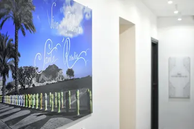 a wall with a picture of a beach and palm trees at iFlat Dalla Zia Anna in Palermo