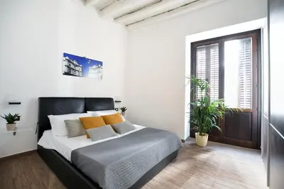 a bedroom with a large bed with yellow pillows at iFlat Dalla Zia Anna in Palermo