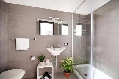 a bathroom with a sink and a toilet and a shower at iFlat Dalla Zia Anna in Palermo