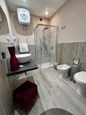 a bathroom with a shower and a toilet and a sink at CB Rooms in Termini Imerese