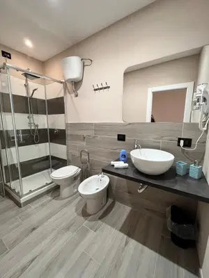 a bathroom with a sink and a toilet and a shower at CB Rooms in Termini Imerese