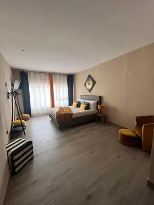 a bedroom with a bed and a couch in a room at CB Rooms in Termini Imerese