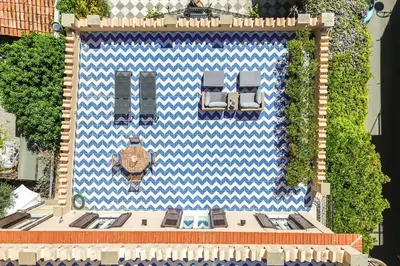 a building with two chairs and a clock on it at I Merli sull'acqua - Suite in Palermo