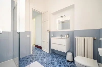 a bathroom with a toilet and a sink and a mirror at I Merli sull'acqua - Suite in Palermo
