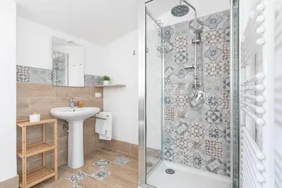 a bathroom with a shower and a sink at Villa Costamante con piscina privata in Balata di Baida