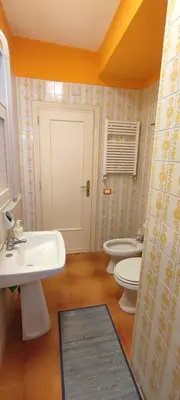 a bathroom with two toilets and a sink at Il Gabbiano al Capo in Palermo