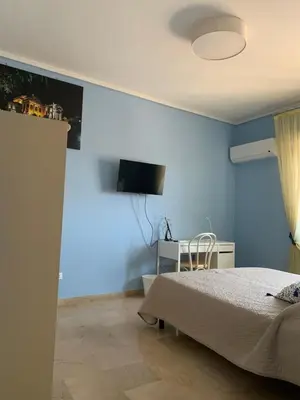 a bedroom with blue walls and a bed and a desk at Il Gabbiano al Capo in Palermo