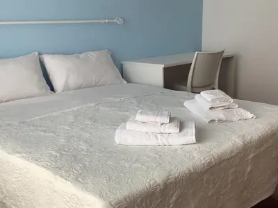 a bedroom with a bed with towels on it at Leo's Home in Palermo