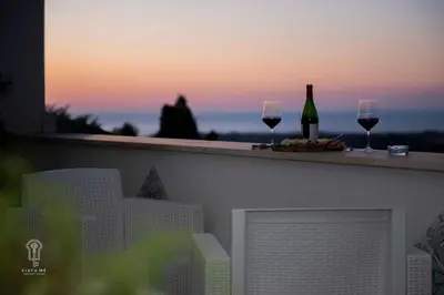 two wine glasses and wine bottles on a ledge at Ciatu mè in Alcamo