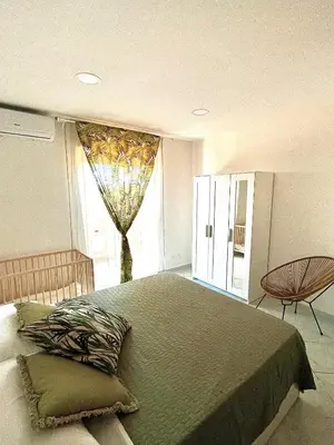 a bedroom with a large bed and a window at Mondello front beach in Palermo