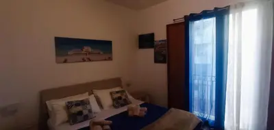 a bedroom with two beds and a window at Al Molo 6 in Palermo