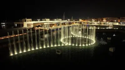 a fountain with lights in the water at night at Al Molo 6 in Palermo