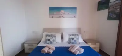 a bedroom with a bed with towels on it at Al Molo 6 in Palermo