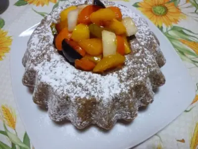 a plate of food with fruit and powdered sugar at B&B Poliglotta in Castelluzzo