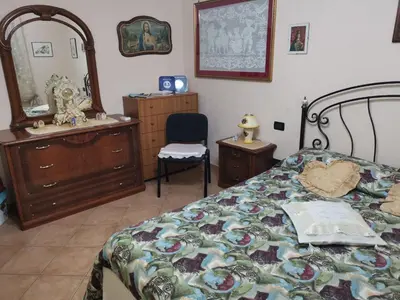 a bedroom with a bed and a dresser and a mirror at B&B La Fenice in Termini Imerese