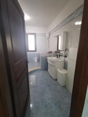 a small kitchen with a sink and a door at B&B La Fenice in Termini Imerese