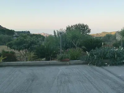 a parking lot with a bunch of plants at B&B La Fenice in Termini Imerese