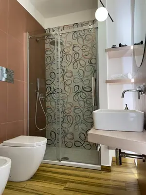a bathroom with a shower and a toilet and a sink at BB4U Apartments al Massimo in Palermo