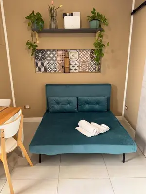a blue couch with two towels on it in a room at CapoCathedral apartment in Palermo