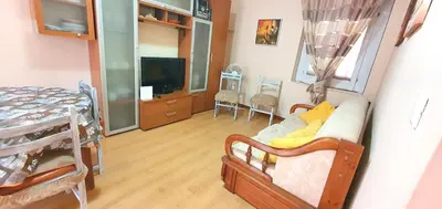 a living room with a couch and a tv and a table at Charming house with sea and mountain views in Alcamo in Alcamo