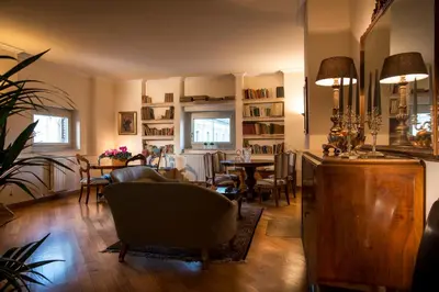 a living room with a table and chairs at Residence Torremuzza - Charming House In The Heart Of Palermo with lovely view in Palermo