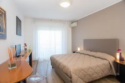 a bedroom with a bed and a desk and a table at Hotel Bel 3 in Palermo