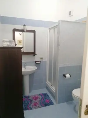 a bathroom with a sink and a toilet and a mirror at Le stanze di Anna in Capaci
