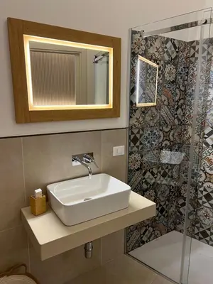 a bathroom with a sink and a shower at Bed and Breakfast Nilu' in Castellammare del Golfo