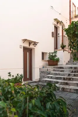 a building with stairs and a door and some plants at Bed and Breakfast Nilu' in Castellammare del Golfo