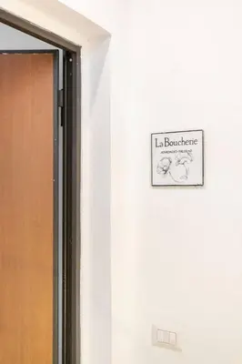 a sign on a wall next to a door at La Boucherie in Palermo