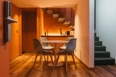a dining room and kitchen with a table and chairs at MONTESANTO36 APARTMENTS in Palermo