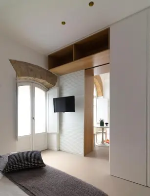 a living room with a sliding door with a flat screen tv at La casetta in centro storico: Pantelleria 9 in Palermo