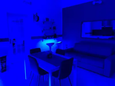 a blue room with a table and chairs and a couch at Loft Nataly in Palermo