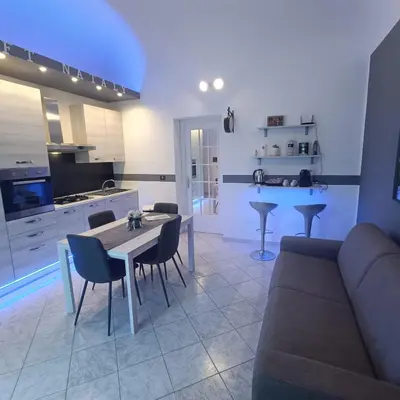 a living room with a couch and a table and chairs at Loft Nataly in Palermo