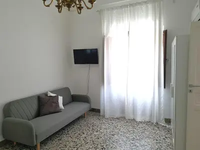 a living room with a couch and a window at Casa Lara in Castellammare del Golfo