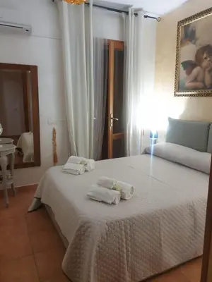 a bedroom with a bed with towels on it at Makari mare in Macari