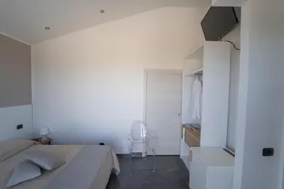 a bedroom with a bed and a closet at B&b Villa Cusenza in Partinico