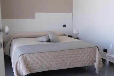 a bed with two pillows on it in a bedroom at B&b Villa Cusenza in Partinico
