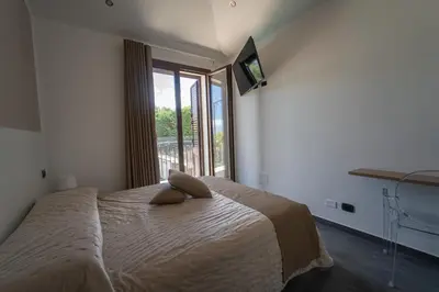 a bedroom with a large bed with a large window at B&b Villa Cusenza in Partinico