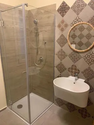 a bathroom with a shower and a sink at Villa Bouganville - charming sea ​​view- 160 mq in Alcamo