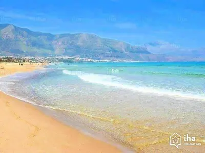 a beach with the ocean and mountains in the background at Villa Bouganville - charming sea ​​view- 160 mq in Alcamo