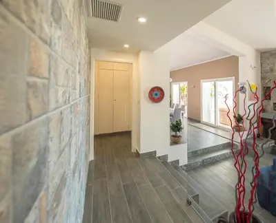 a hallway of a home with a stone wall at La Villa di Sofia in Santa Flavia