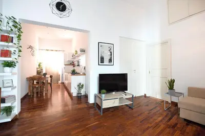 a living room with a television and a couch at iFlat Key House tra il centro e il mare in Palermo
