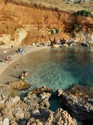 a group of people in the water at a beach at Villa Noemy in Castellammare del Golfo