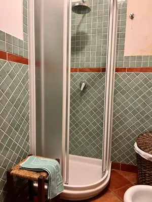 a shower in a bathroom with green tile at IL Rustico di Giò in Carini