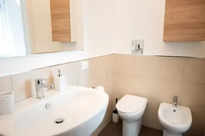 a bathroom with a white sink and a toilet at Casa di Dada - statua in Palermo