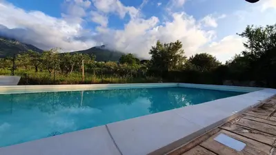 a swimming pool with a view of a mountain at Marosa Casa Vacanze in Torretta