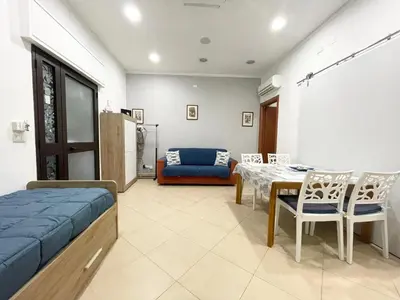 a bedroom with a bed and a table and chairs at Domus Rosaliae - Casa Vacanze in Palermo